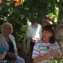 Gwen Clancy and others in the garden listening to Emma George