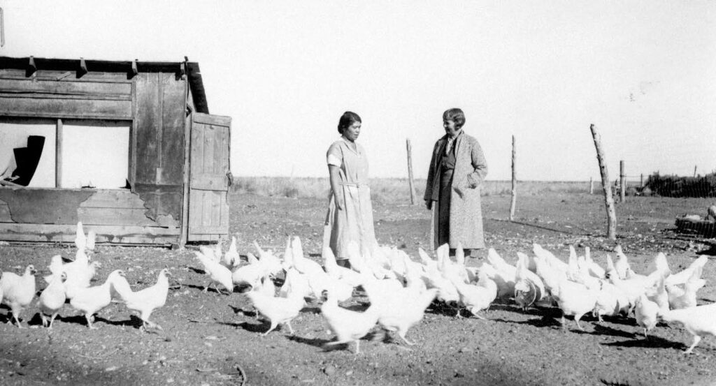 Alida Bowler (on right) visits a reservation chicken farm.